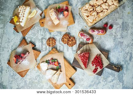 Assorted Sweet Desserts. Top View. Gray Textured Background. Beautiful Serving Dishes. Dessert. Food