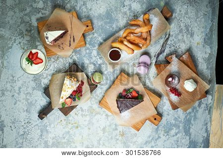 Assorted Sweet Desserts. Top View. Gray Textured Background. Beautiful Serving Dishes. Dessert. Food