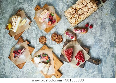 Assorted Sweet Desserts. Top View. Gray Textured Background. Beautiful Serving Dishes. Dessert. Food
