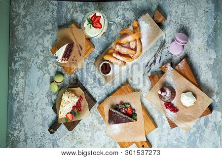 Assorted Sweet Desserts. Top View. Gray Textured Background. Beautiful Serving Dishes. Dessert. Food