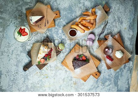 Assorted Sweet Desserts. Top View. Gray Textured Background. Beautiful Serving Dishes. Dessert. Food