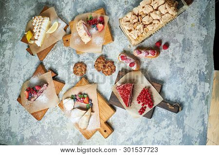 Assorted Sweet Desserts. Top View. Gray Textured Background. Beautiful Serving Dishes. Dessert. Food