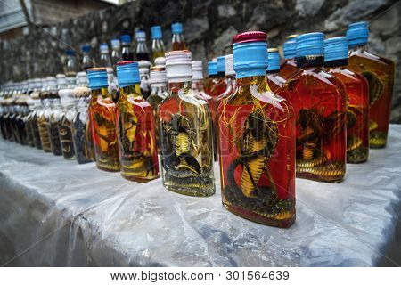 Bottle Of Alcohol Containing Liquor With Cobra Snake And Scorpion Inside On A Market On Cambodia. Tr