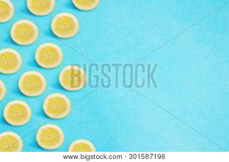 Lemon Border On A Bright Blue Background. Flat Lay Summer Concept.