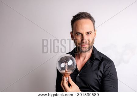 Handsome man holding a snowglobe.