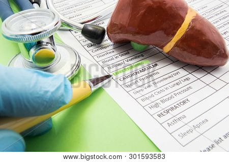 Liver Problems Concept Photo. The Doctor Points In Diagnosis Process To Inscription Liver Problems O
