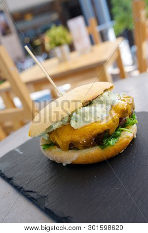 Burger with cheese and lettuce.