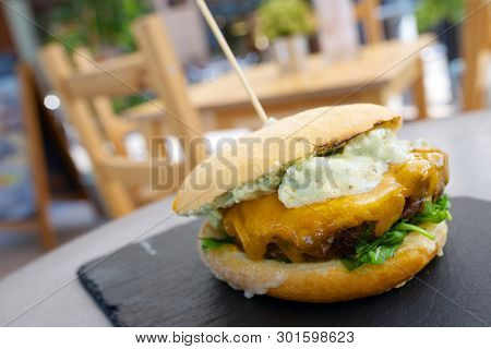 Burger with cheese and lettuce.