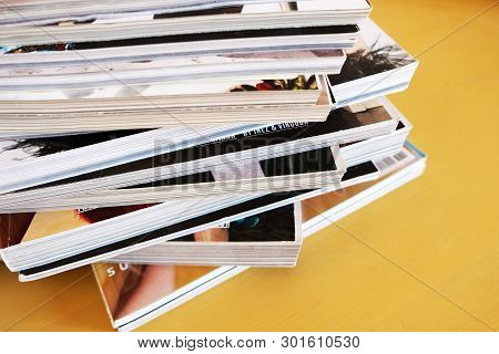 Pile Of Printed Magazines On Yellow Background