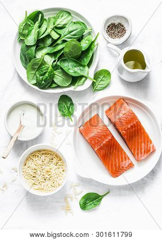 Ingredients For A Balanced Lunch - Salmon Fish, Spinach, Cream, Orzo Pasta On A Light Background, To