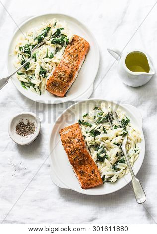 Healthy Balanced Lunch - Creamy Spinach Orzotto And Baked Salmon On A Light Background, Top View