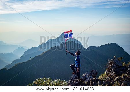 Chiang Dao, Chiang Mai, Thailand - February 2019 : Asian Trekking Man Holding Thailand Flag At The T