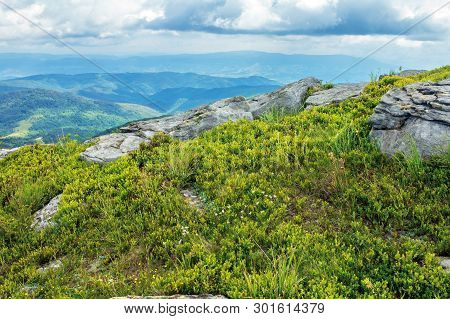 Rocks On The Grassy Hill. Beautiful Summer Landscape In Mountains. Cloudy Sky Above The Ridge. Wonde
