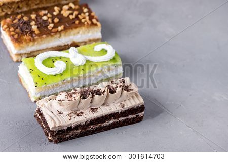 Assorted Different Mini Cakes With Cream Coffee Chocolate Salted Caramel And Berries Above Horizonta