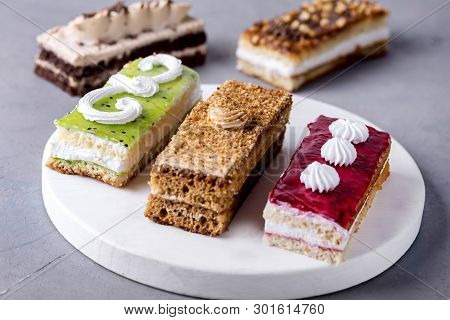 Assorted Different Mini Cakes With Cream Coffee Chocolate Salted Caramel And Berries Above Horizonta