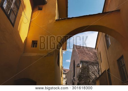 Church Of The Dominican Monastery In Sighisoara, Viewed Through An Archway