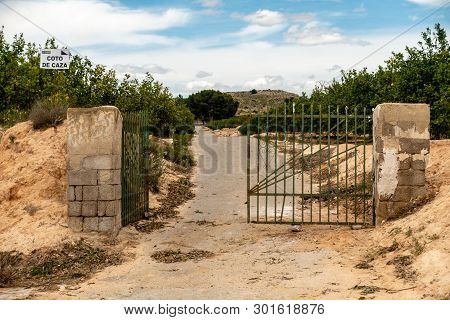 Home Reserve In Spain With Iron Gates And Warning Sign