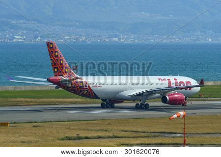 Passenger Airplane Taxiing On Runway