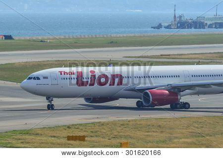 Passenger Airplane Taxiing On Runway
