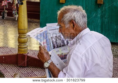 An Old Man Reading News On The Morning