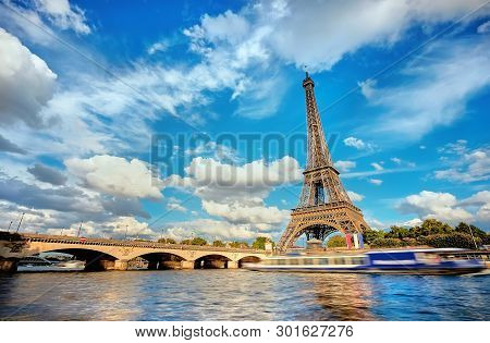 Cityscape Of Paris With The Eiffel Tower On A Sunny Day, Long Exposure To Show Motion Of Touristic B
