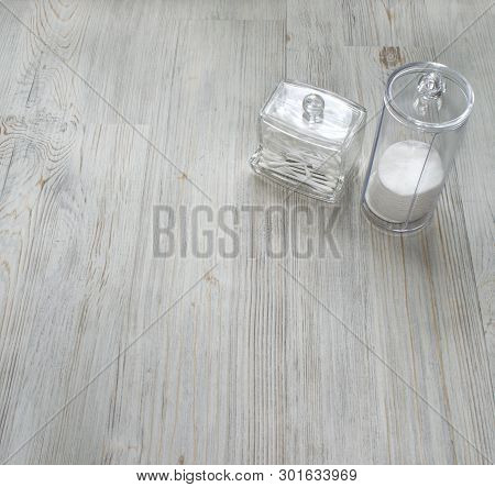 Cosmetic Flatlay On Grey Wooden Table. Beauty Set Of Plastic Containers With Q-tips And Disks. Space