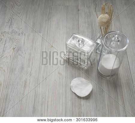Cosmetic Flatlay On Grey Wooden Table. Beauty Set Of Plastic Containers With Q-tips And Disks. Space