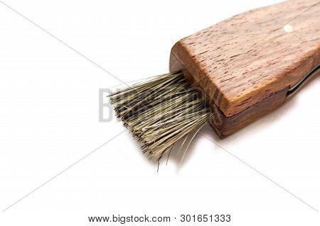 A Fleecy Brush And Wooden Handle. Small Narrow Brush. Brush At An Angle.