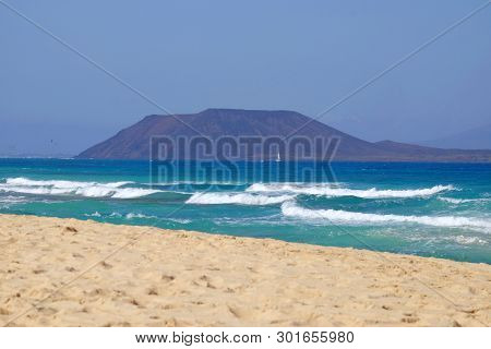 Beach Corralejo On The Canary Island Fuerteventura, Spain. View On The Islands Lobos And Lanzarote.
