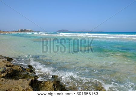Beach Corralejo On The Canary Island Fuerteventura, Spain. View On The Islands Lobos And Lanzarote.