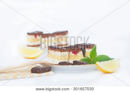 Pieces Of Lemon Sponge Cake With Chocolate Glaze On A Plate. Homemade Lemon Cake.