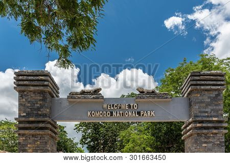 Komodo Island, Indonesia - February 24, 2019: Komodo National Park. Sign On Top Of Brown Brick Gate 
