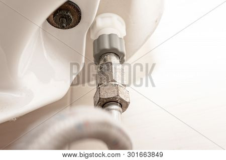 Water Supply Fitting Of Cistern Tank Of The Toilet Bowl At Water Closet Close Up