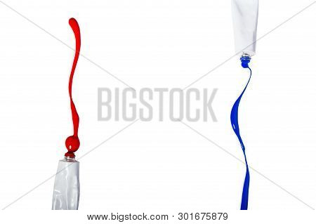 Red And Blue Acrylic Paint Is Poured From The Tubes Onto An Isolated Background.
