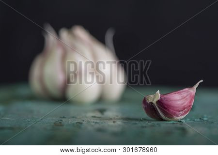 Fresh Garlic Bulbs On Turquoise Wooden Kitchen Table, Healthy Everyday Eathing Background