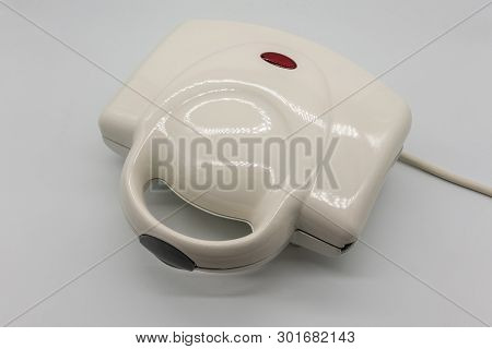 White Grossy Toaster With Red Light Isolated On White Background.