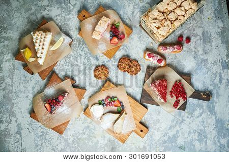 Assorted Sweet Desserts. Top View. Gray Textured Background. Beautiful Serving Dishes. Dessert. Food