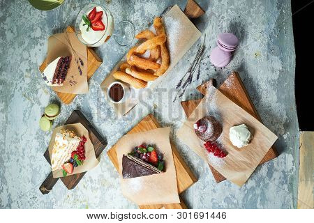 Assorted Sweet Desserts. Top View. Gray Textured Background. Beautiful Serving Dishes. Dessert. Food