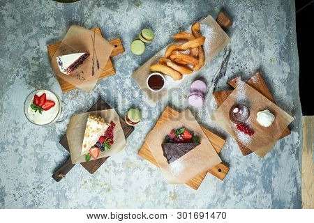 Assorted Sweet Desserts. Top View. Gray Textured Background. Beautiful Serving Dishes. Dessert. Food