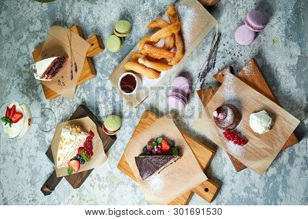 Assorted Sweet Desserts. Top View. Gray Textured Background. Beautiful Serving Dishes. Dessert. Food
