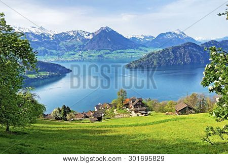 View Of Lake Lucerne Or Vierwaldstaetersee With Vitznau Settlement And Swiss Alps In The Background 