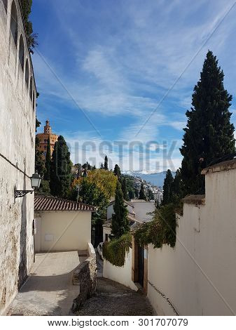 Granada Street In The Realejo Neighborhood With Views Of The Sierra Nevada