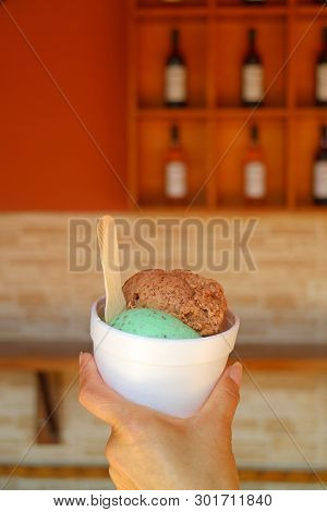 Woman Hand Holding Two Scoops Of Lucuma Fruit And Mint Choc Chip Ice Cream Cup, Ica Region, Peru