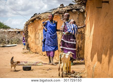 Masai Village, Kenya - October 11, 2018: Unindentified African Women Wearing Traditional Clothes In 