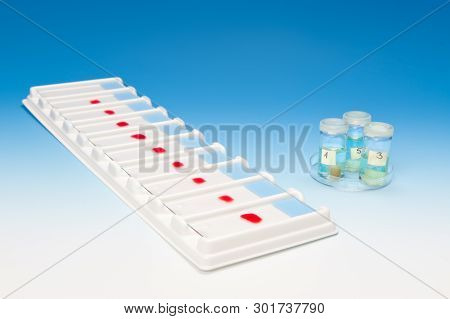 Array Of Blood Samples For Microscopy And Biopsy Tissue On Blue Gradient Background