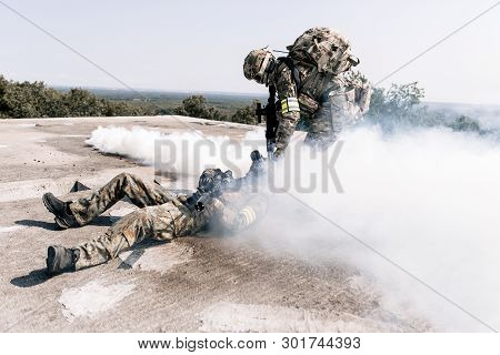 United States Army In Action, Camouflage And Army Helmet. Military Action In The Open Air, Rescue A