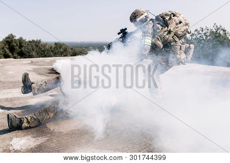 United States Army In Action, Camouflage And Army Helmet. Military Actions In The Open Air, The Sold
