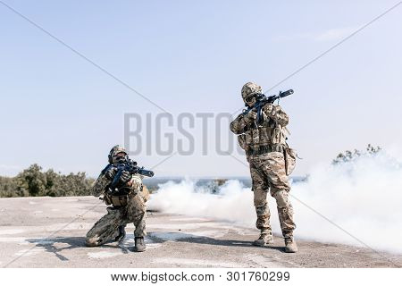 Military With Sniper Rifles Preparing To Fire On The Enemy Standing In The Open Air