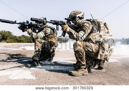 Group Of Armed Man In Camouflage With Sniper Gun In Hand