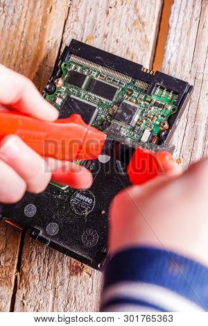 A Man Breaks A Computer Using Locksmith Tools.